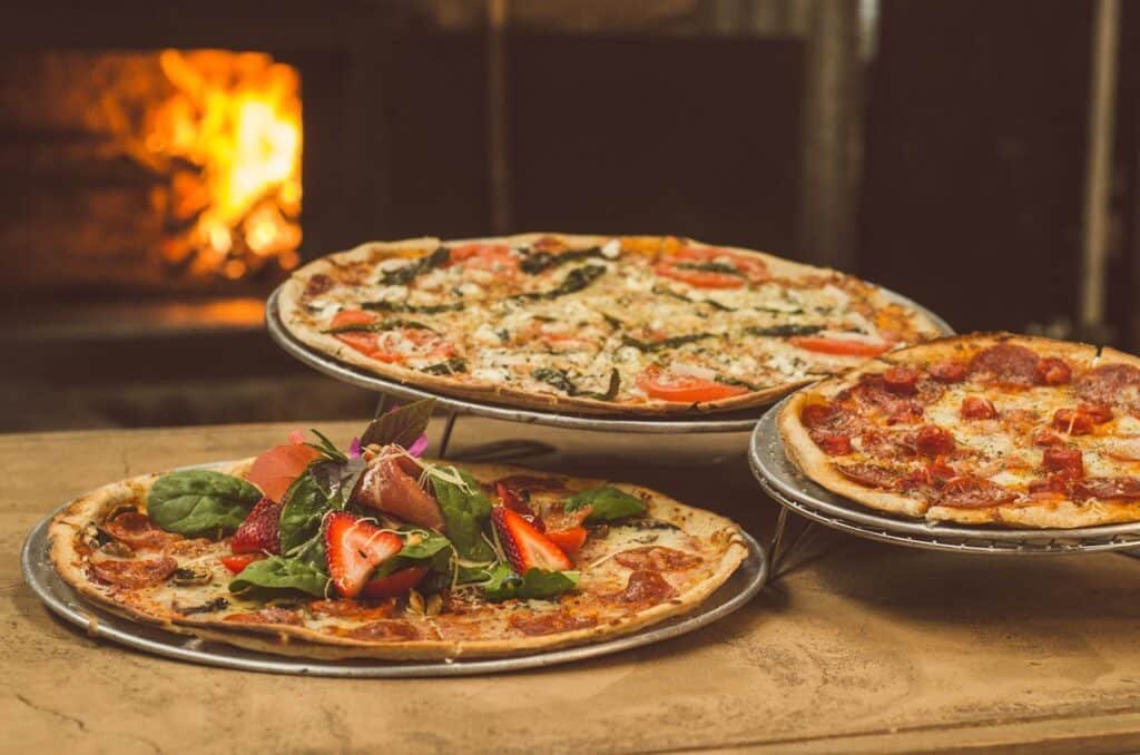 3 different sizes of pizzas on the table