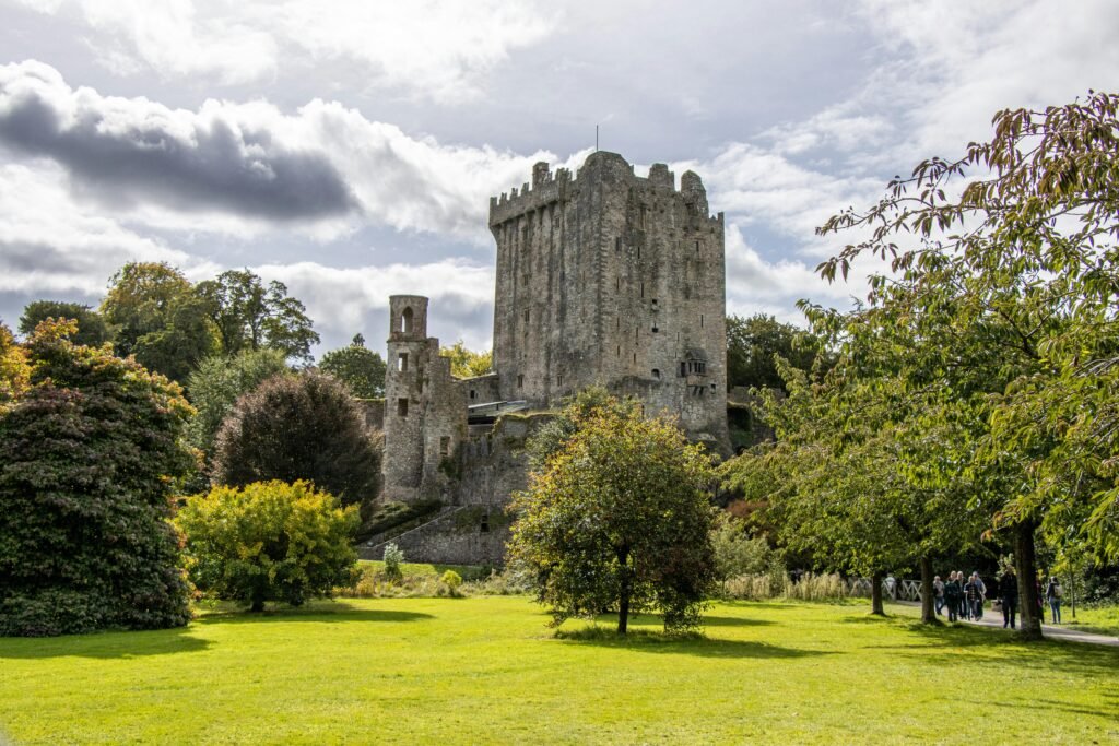 Blarney Castle surrounded by vibrant greenery in County Cork, Ireland, where people kiss upside down