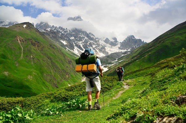 two persons hiking in the mountain valley