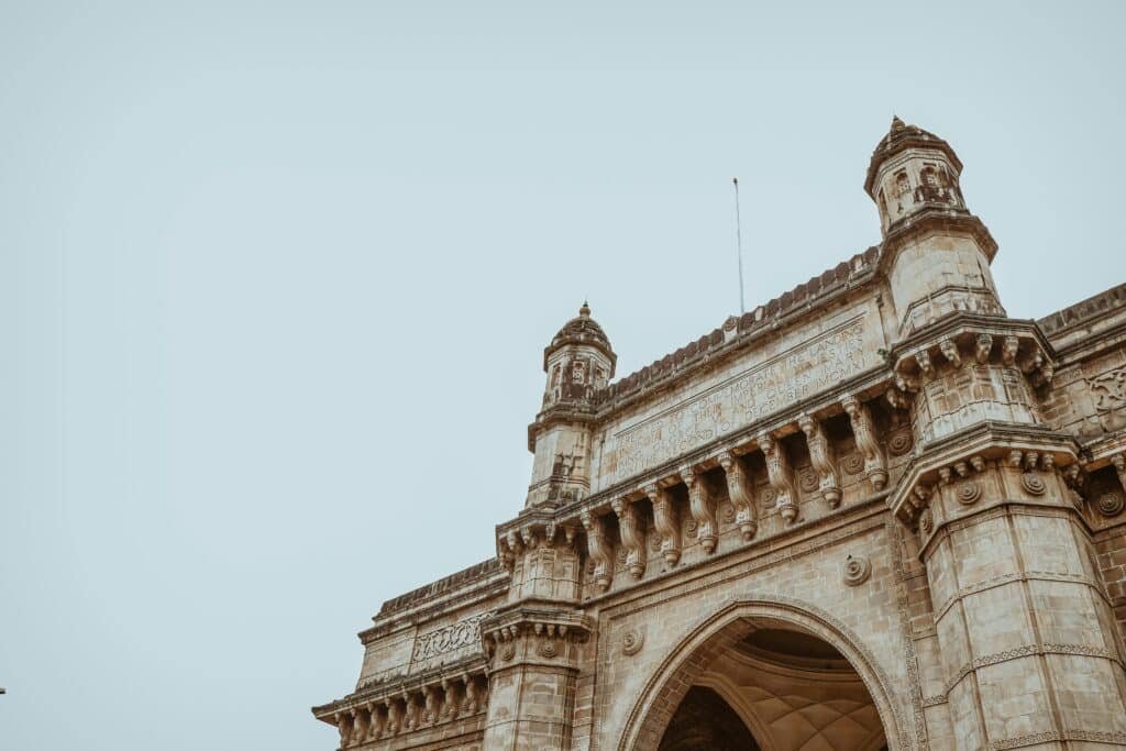 Low angle view of the Gateway of India showcasing intricate architectural design in Mumbai representing best places in India