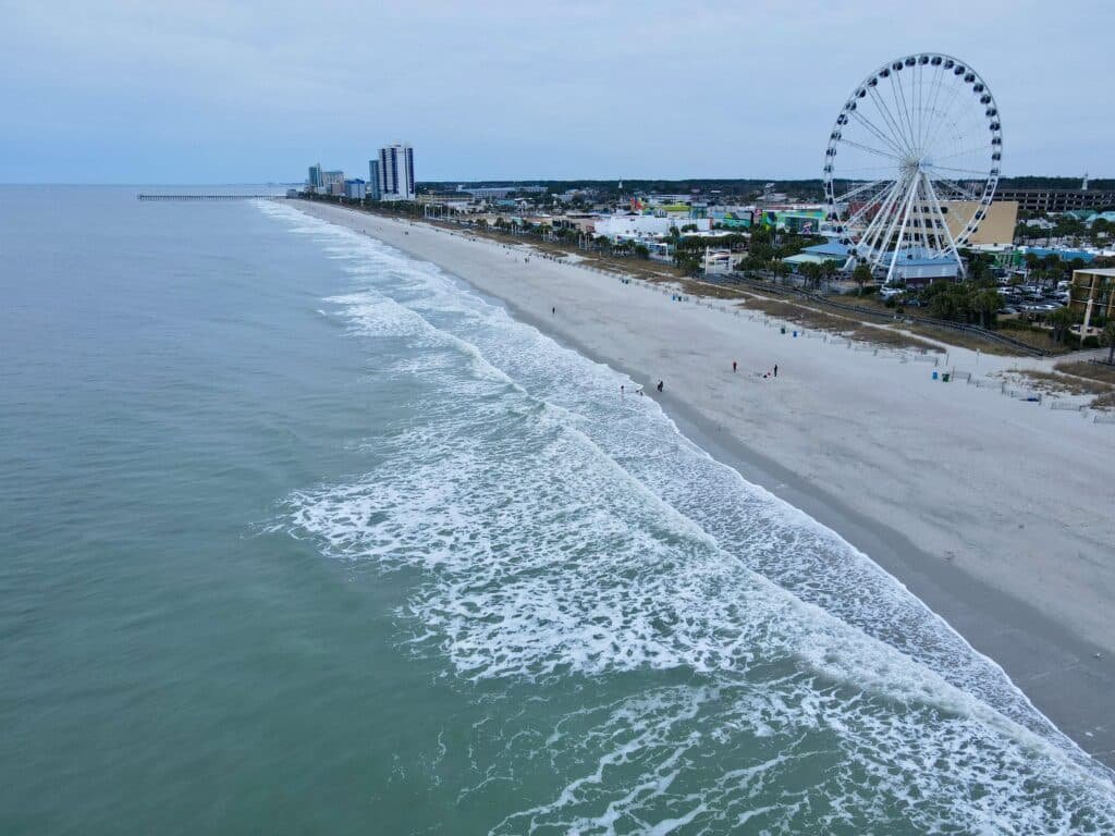 Aerial view of Myrtle Beach coastline with iconic ferris wheel showcasing the beachfront and skyline   Touring Diary Adventure