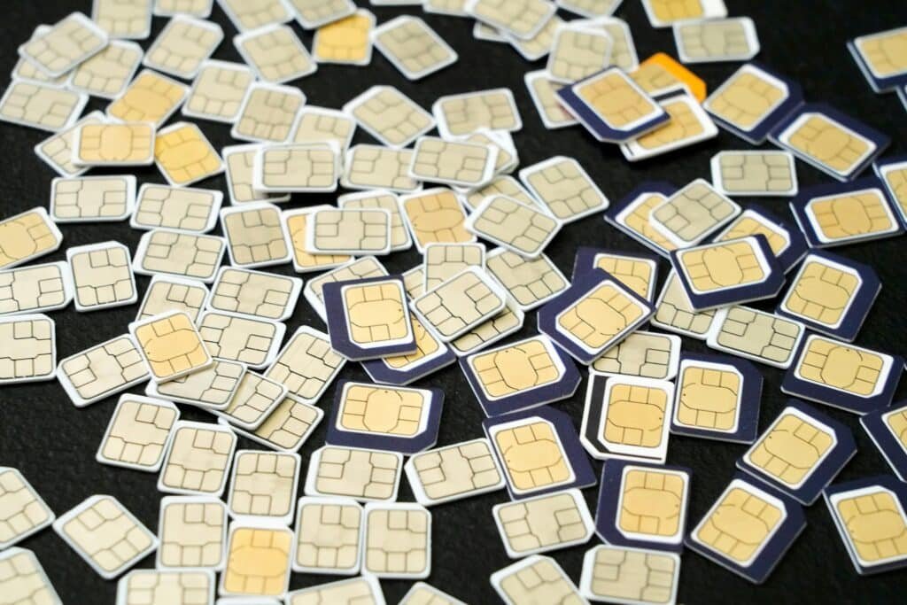 Multiple SIM cards scattered on a black surface showcasing the complexity of cellular technology representing What Documents Are Needed for SIM Replacement