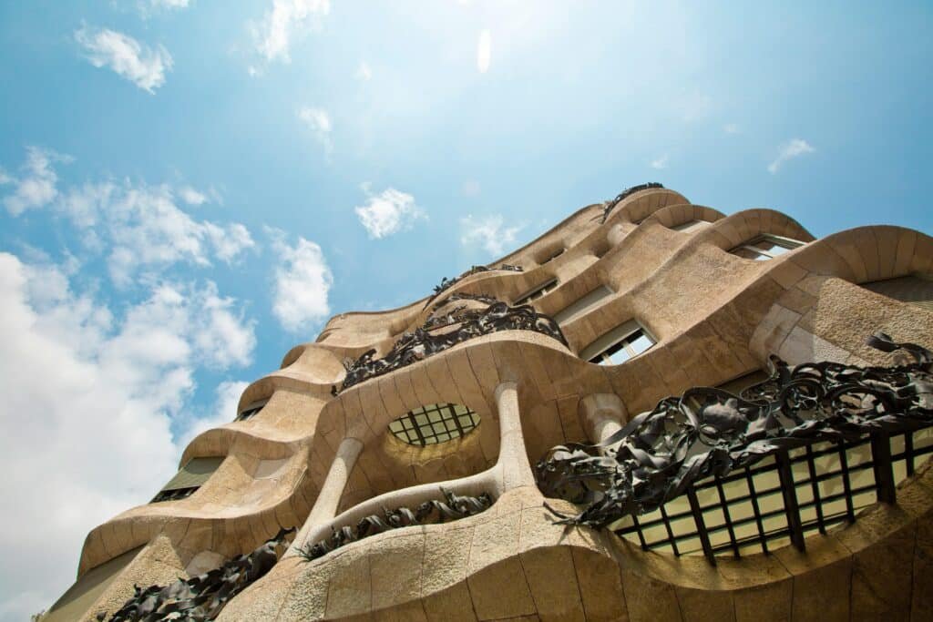 Low angle view of the Mandarin Oriental Barcelona unique architectural facade against a vibrant sky