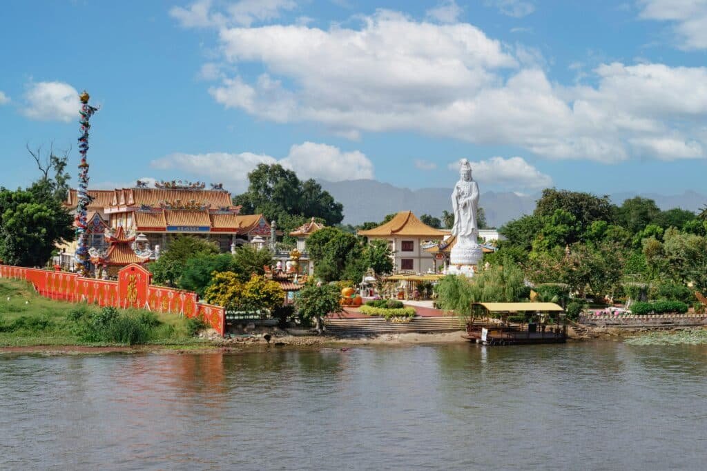 lot of sky tall buildings river trees representing Best Time to Travel to Thailand   Touring Diary Adventure