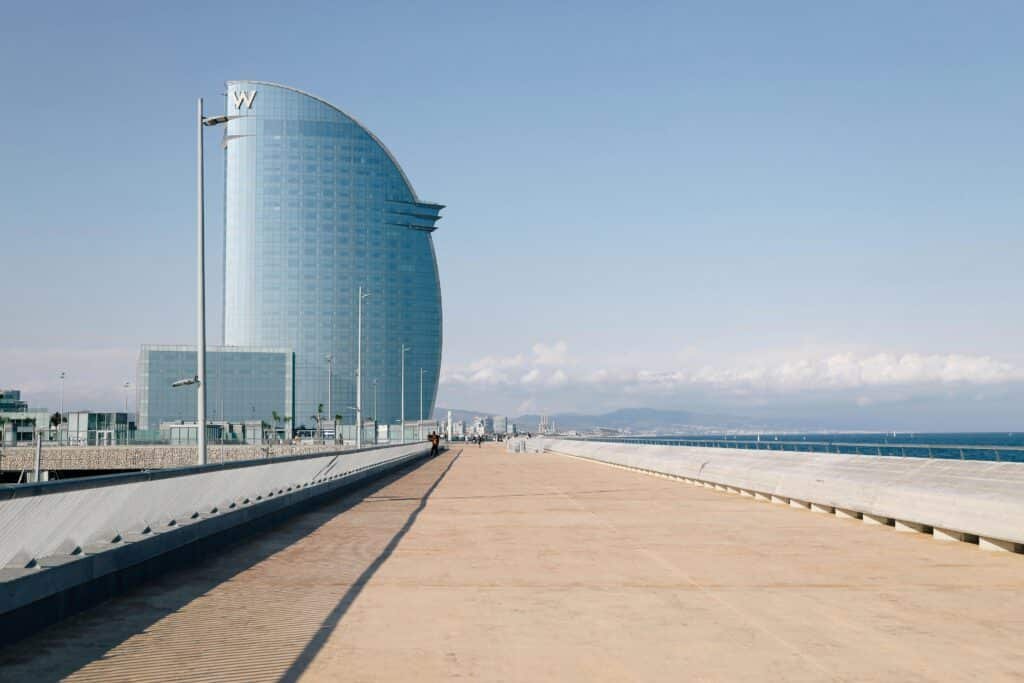 Iconic W Barcelona hotel with stunning design against a clear sky on a serene pier setting