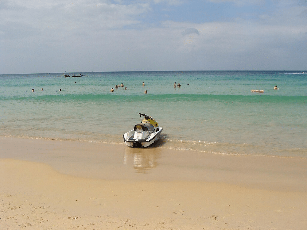 Plunket Thailand where sky blue, boat in the sea and sand representing Best Time to Travel to Thailand.
